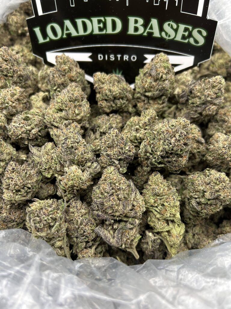 Close-up of Banana Kush cannabis flower with frosty trichomes and bright green buds