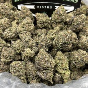 Close-up of Banana Kush cannabis flower with frosty trichomes and bright green buds