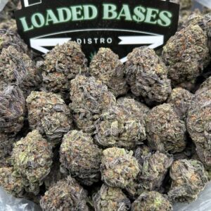 Close-up of Birthday Cake cannabis flower with frosty trichomes and purple hues