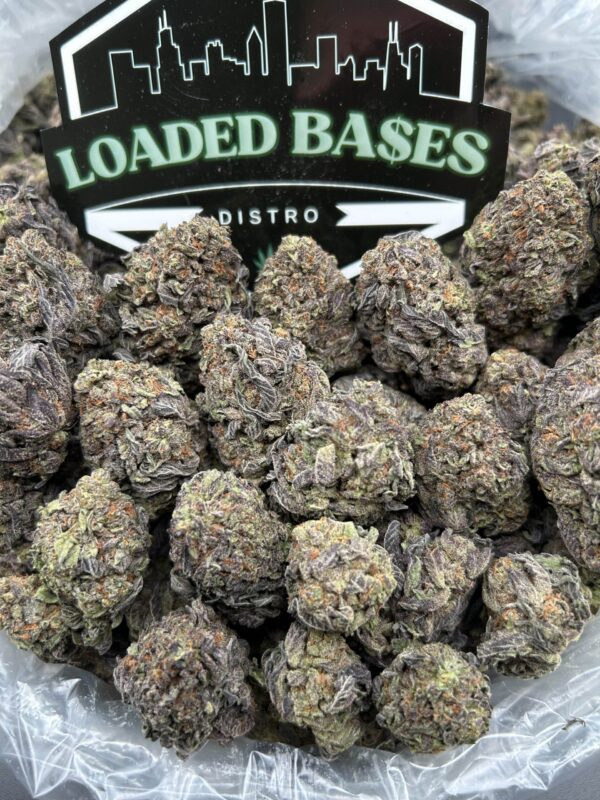 Close-up of Birthday Cake cannabis flower with frosty trichomes and purple hues