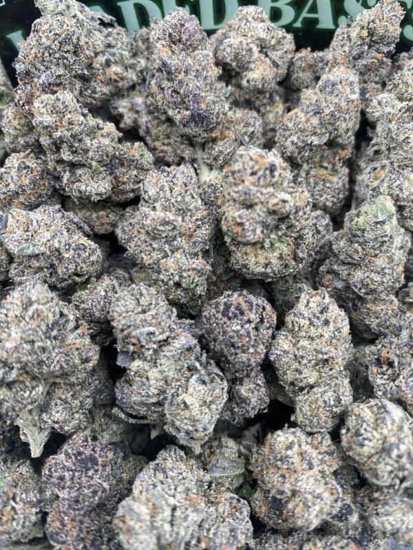 Close-up of Black Cherry Gelato cannabis flower with dense purple and green buds and sparkling trichomes