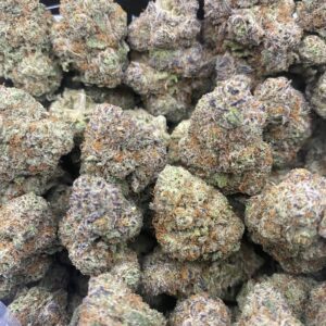 Grape Gas hybrid cannabis buds with deep purple and green hues, covered in frosty trichomes