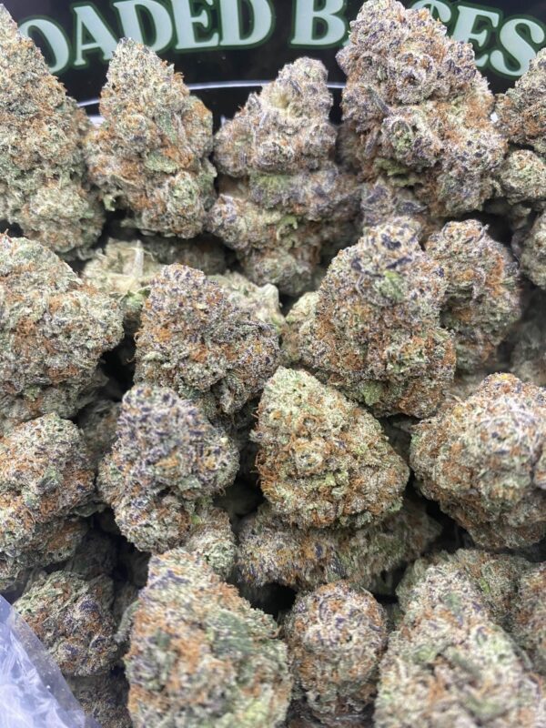 Grape Gas hybrid cannabis buds with deep purple and green hues, covered in frosty trichomes
